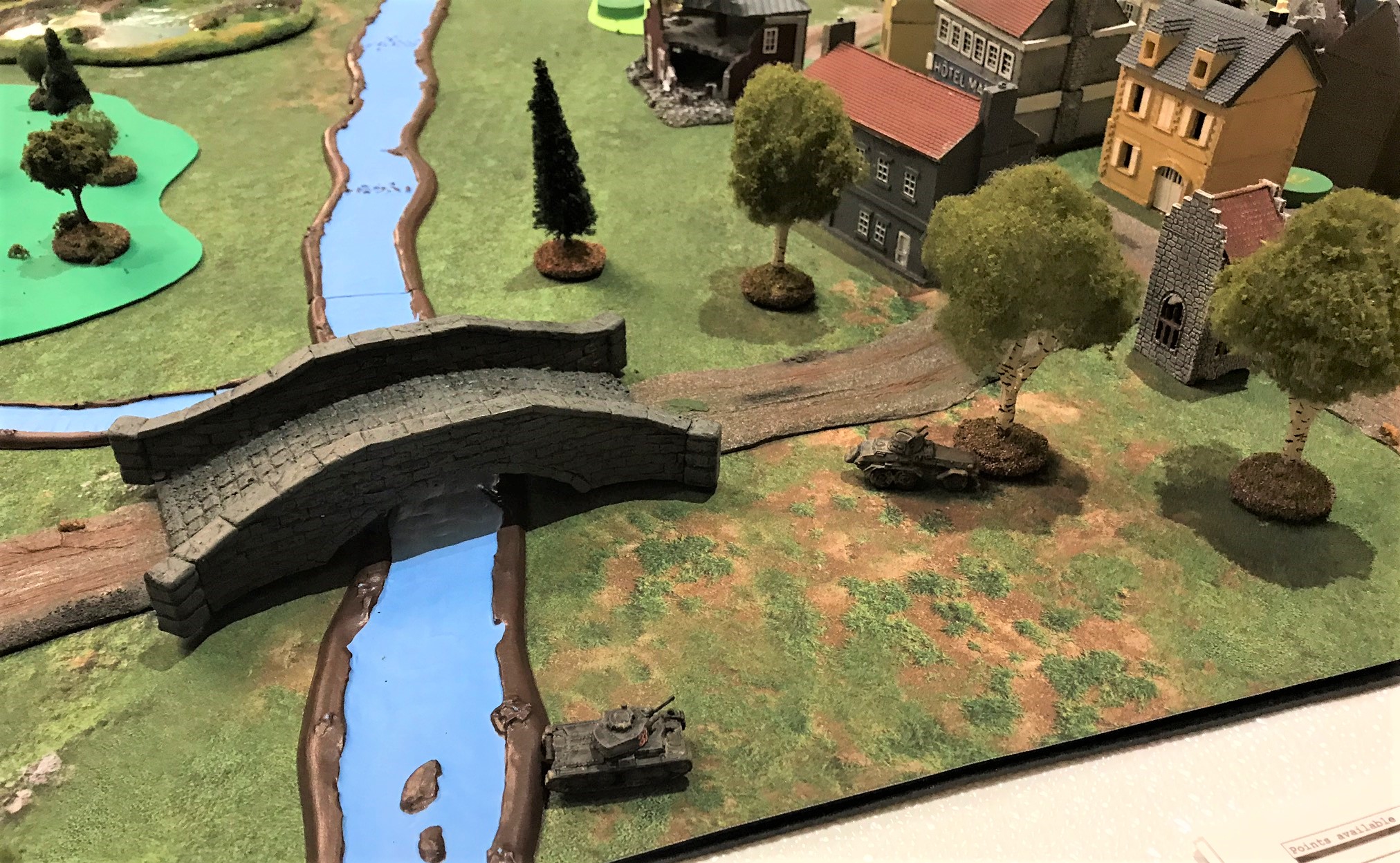 1 Sd.Kfz. 231 and Panzer 38(t) skirt the town