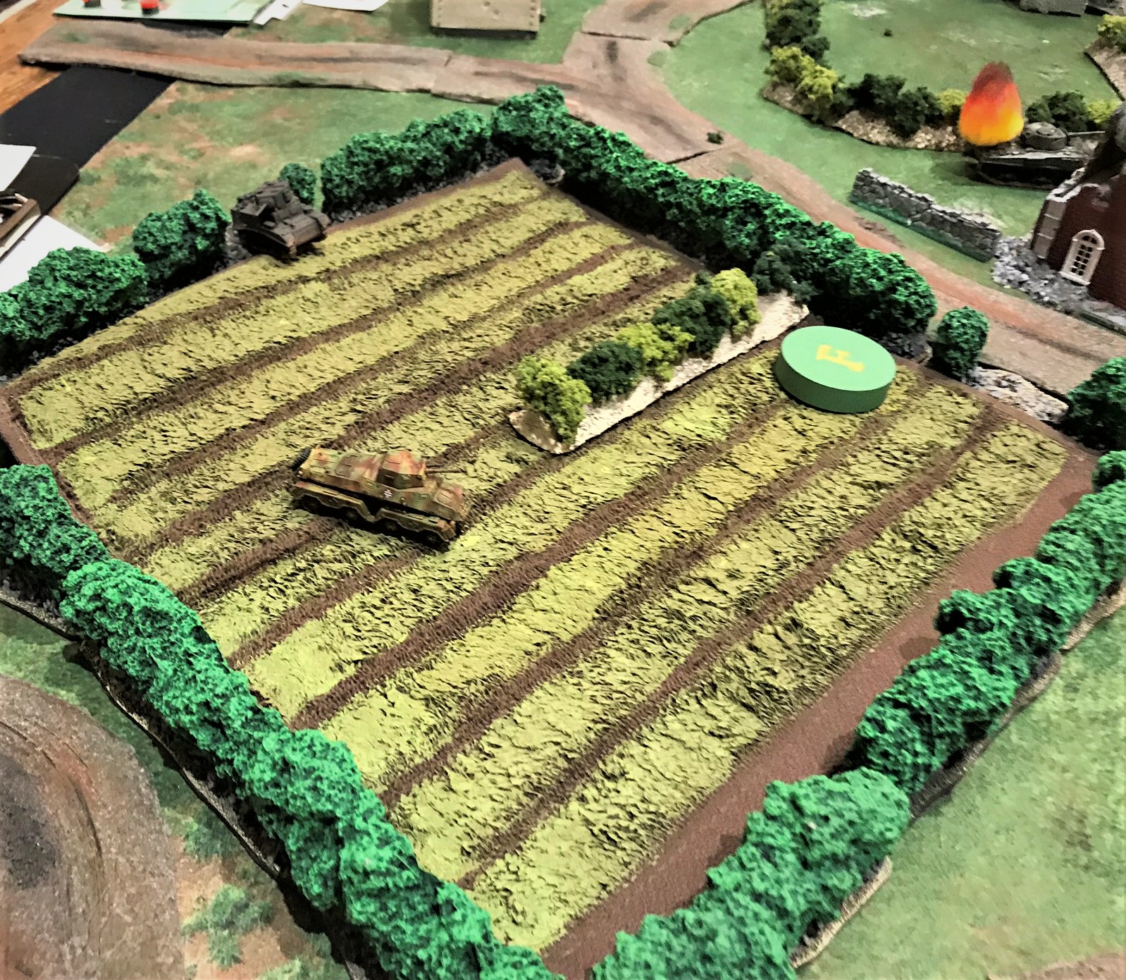 2 Sd.Kfz. 231 is pursued by M5 Stuart with Brit M4 Sherman burning